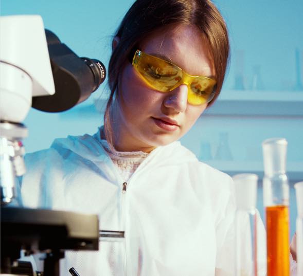 Young lady in a lab setting mixing chemicals.