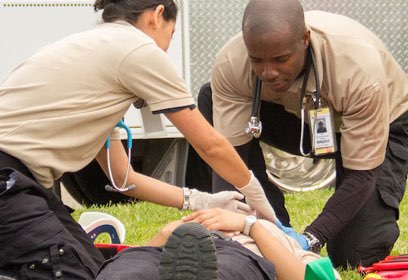 EMT helping a patient on the ground