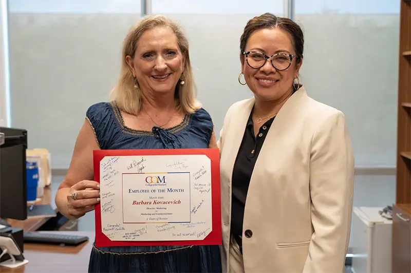 Employee of the Month Barbara Kovacevich receiving certificate from COM president Dr. Helen Castellanos Brewer