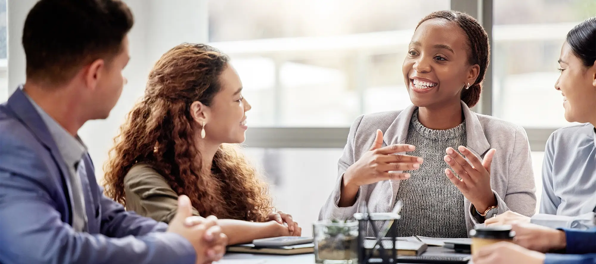 Group of business professionals talking at a table. 