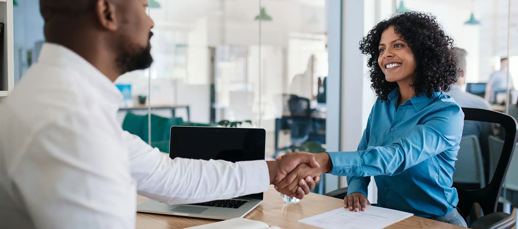 New hire shaking hands with interviewer.