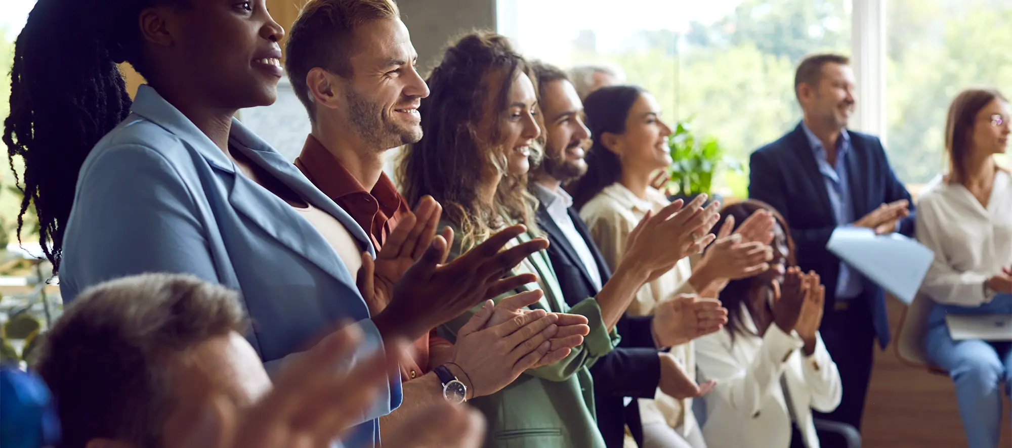 Group of leadership figures clapping.