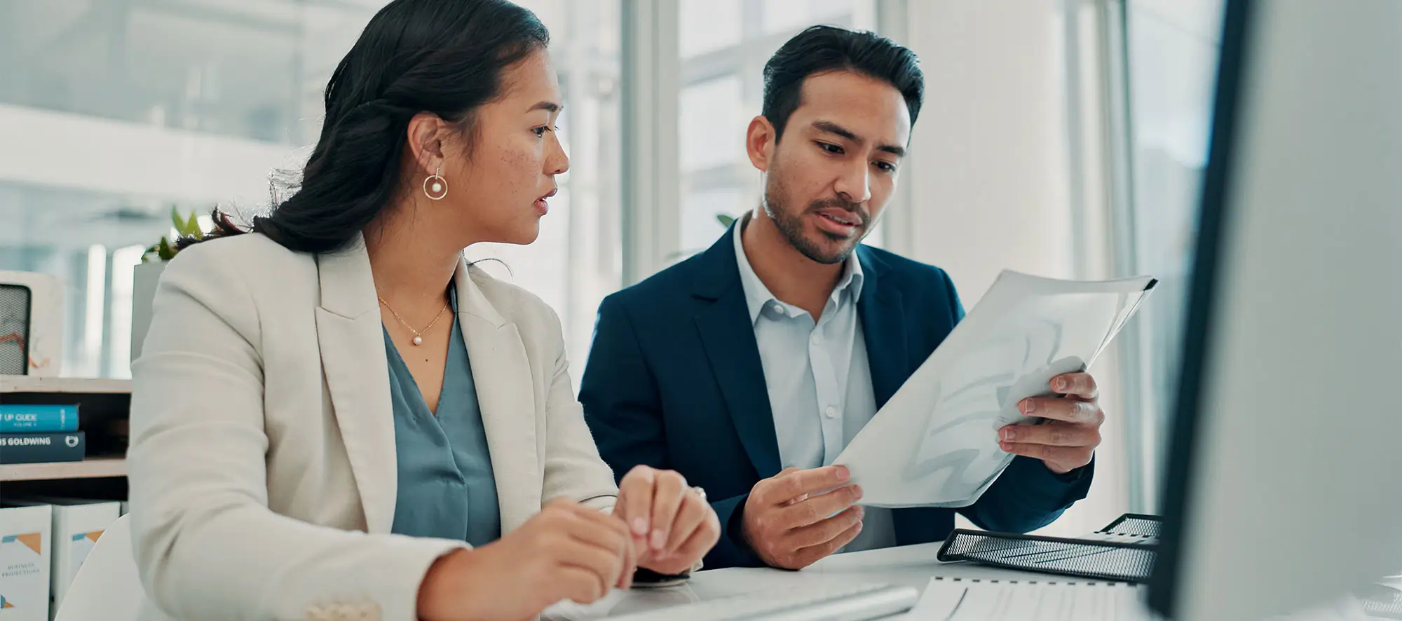 Corporate man and woman with financial documents.