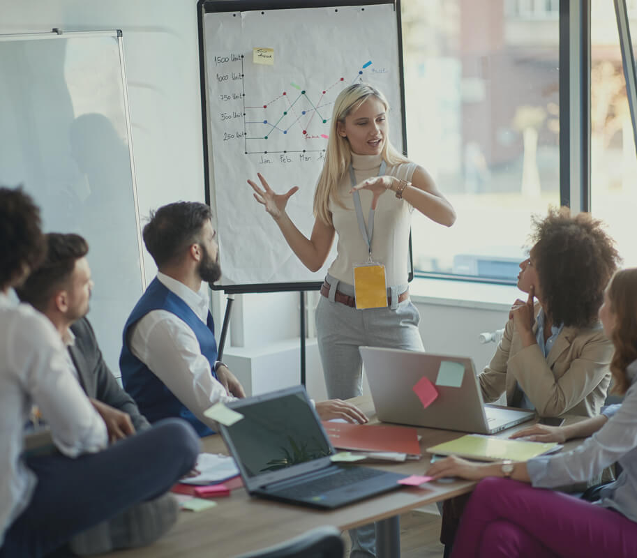 Business woman presents her idea to working team.