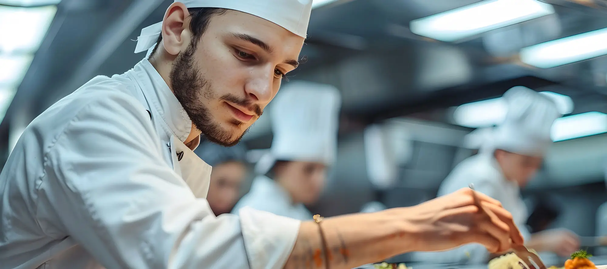A group of culinary students working together in a professional kitchen.