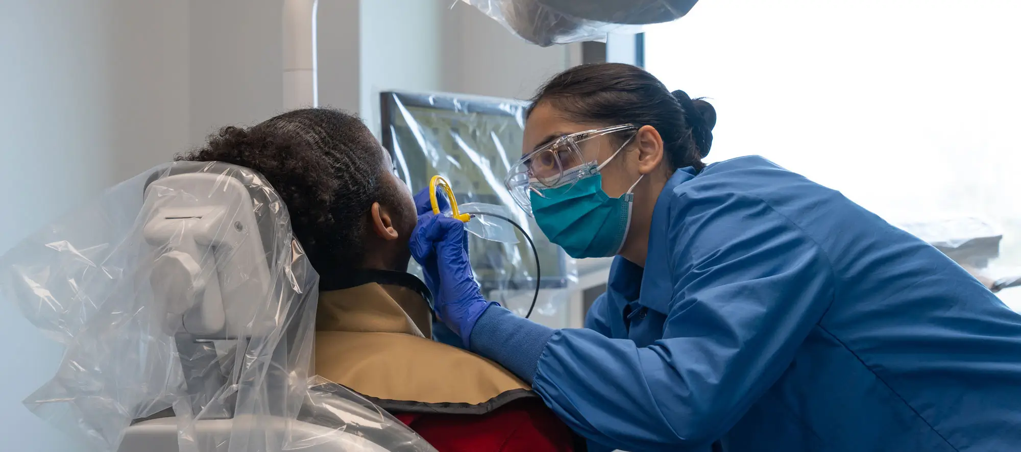 Dental hygienist cleaning teeth