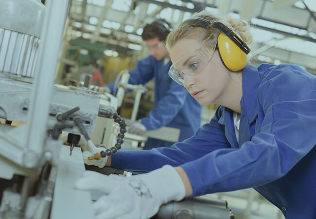 Woman working on industrial equipment