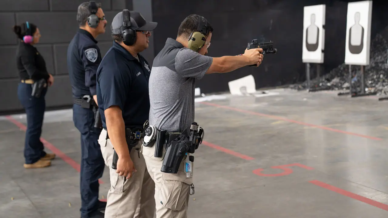 Instructor with group at range shooting