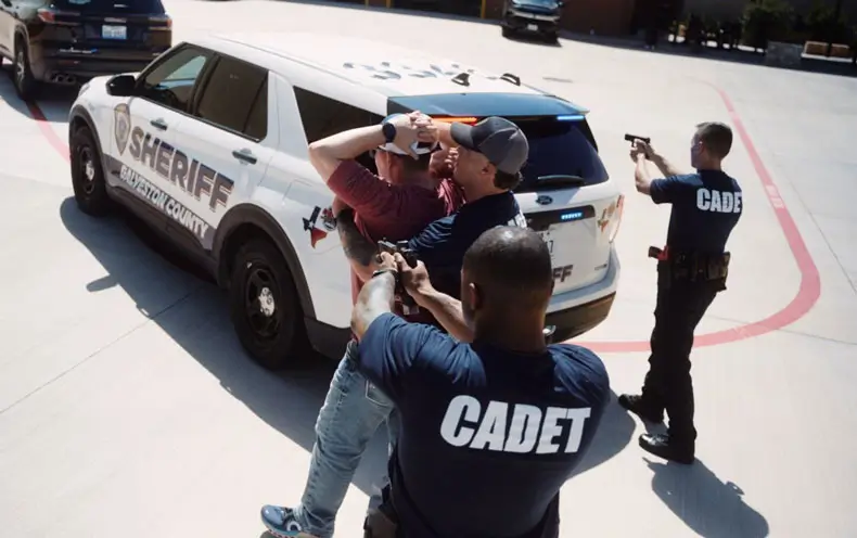 Cadets training with guns drawn arresting a suspect