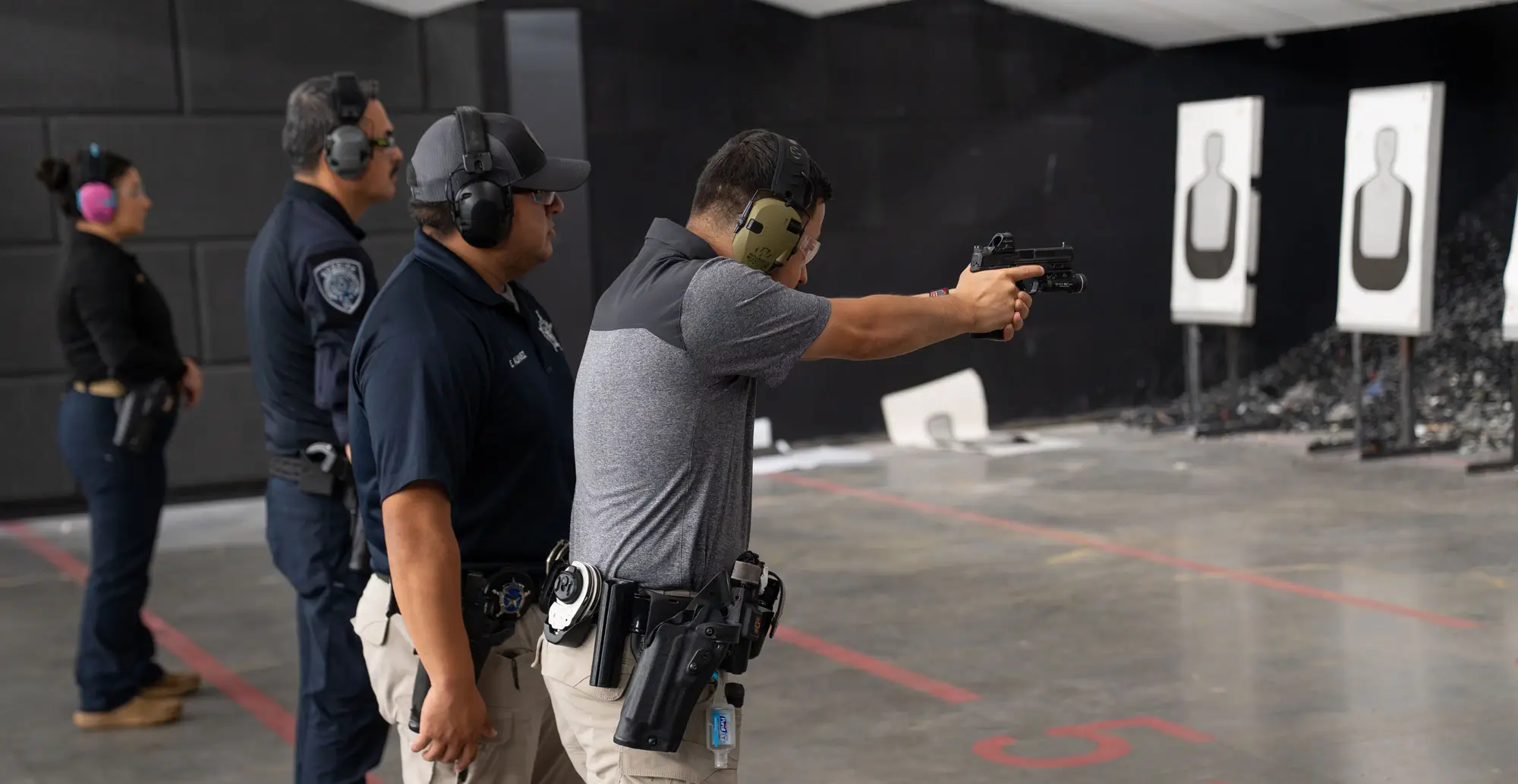 Group of cadets and trainer standing in firing range
