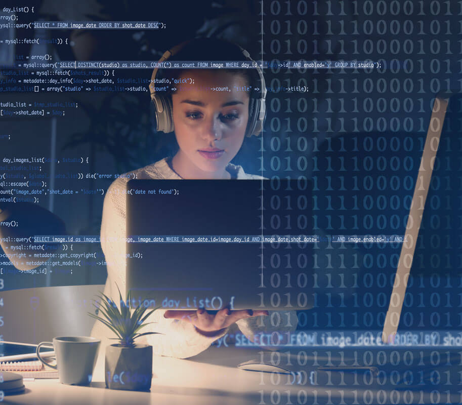 Young woman listening to music while working with laptop.