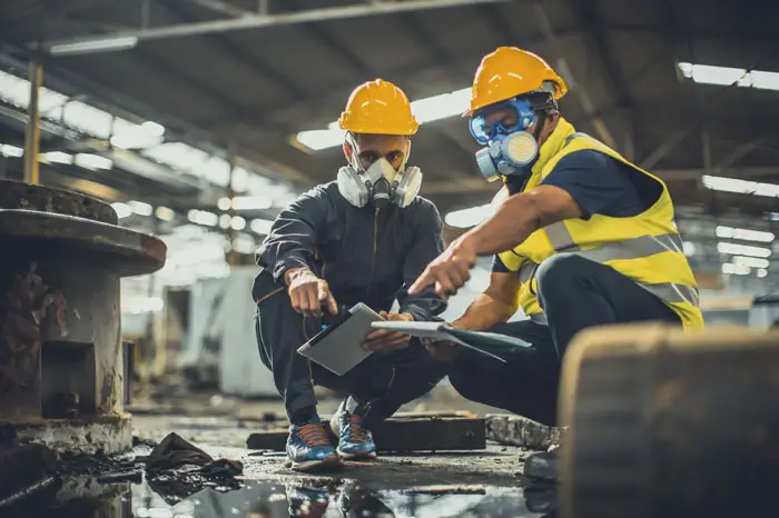 Toxic chemical gas leak safety team working cleaning in danger factory workshop environment contamination safety and protection.