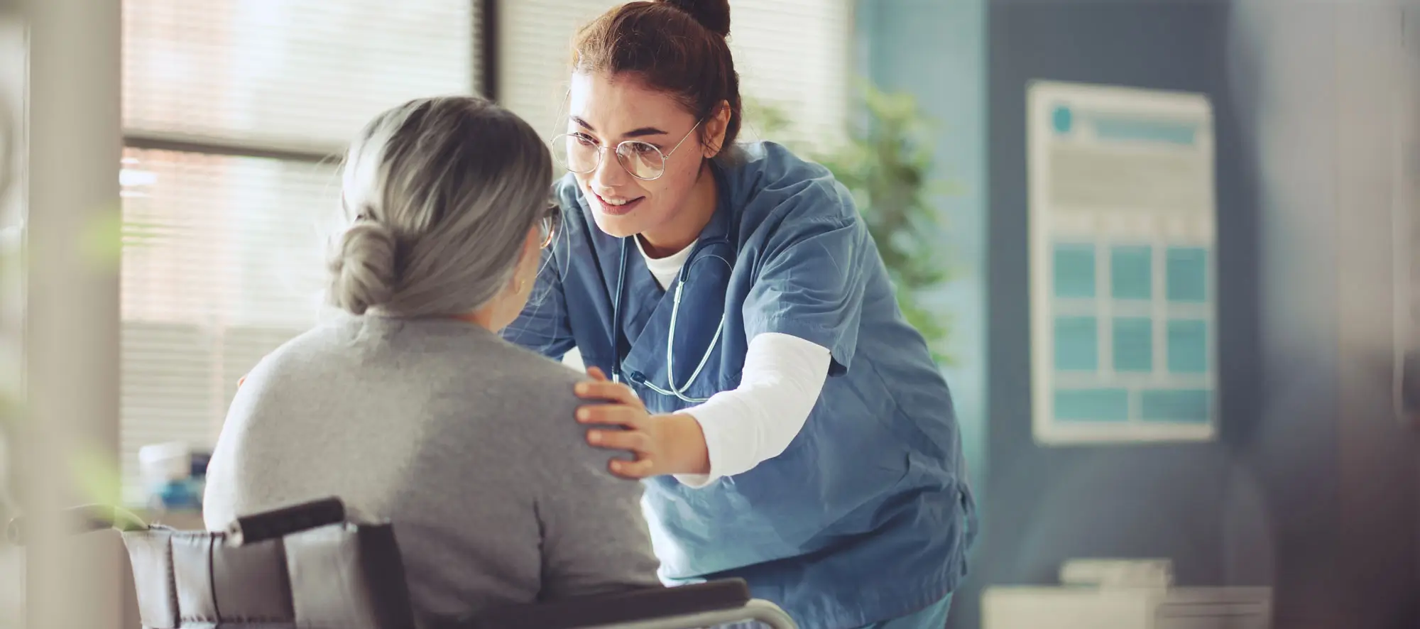 Senior woman in a wheelchair being cared for a nurse