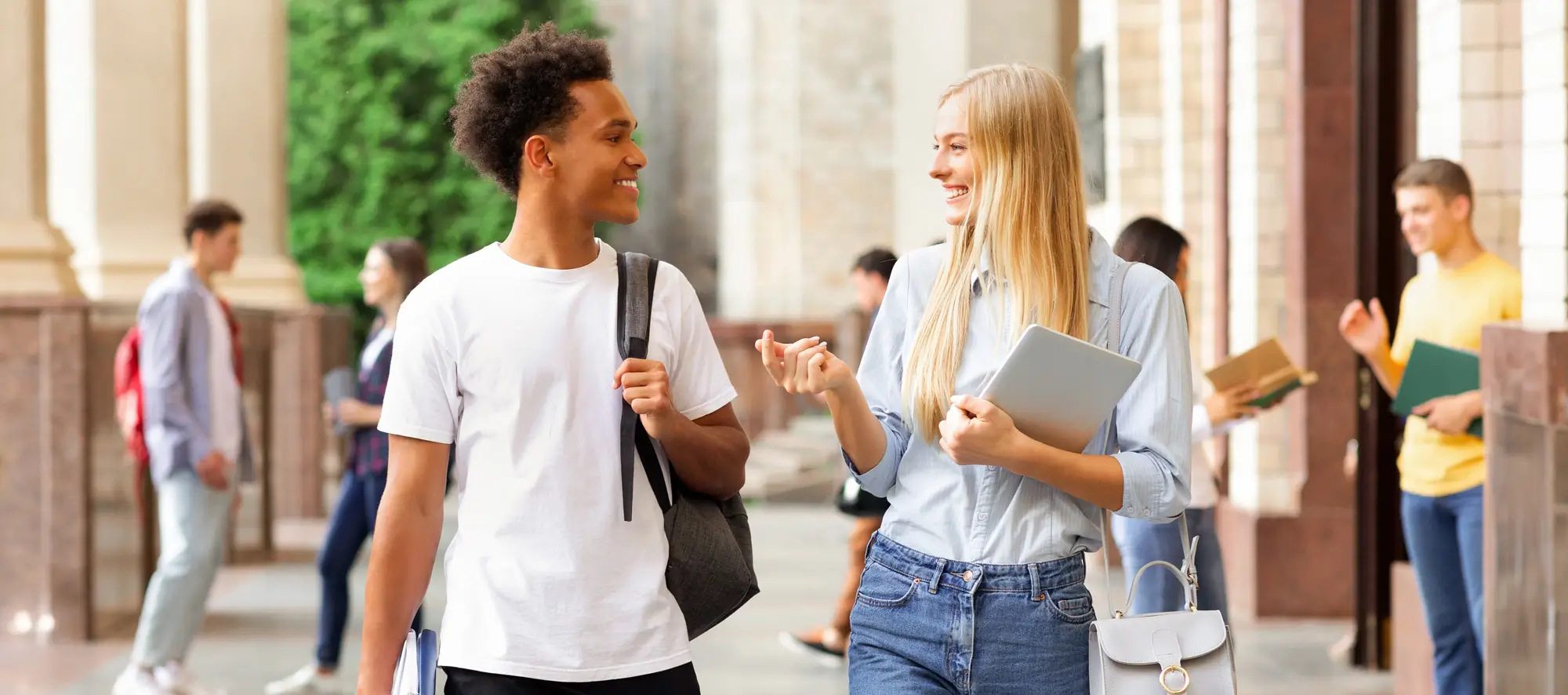 Multiracial students walking in university campus during break