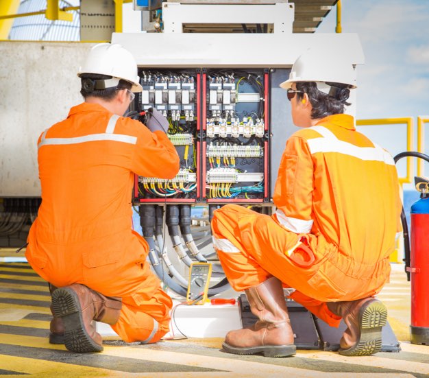 Two techs working on a panel