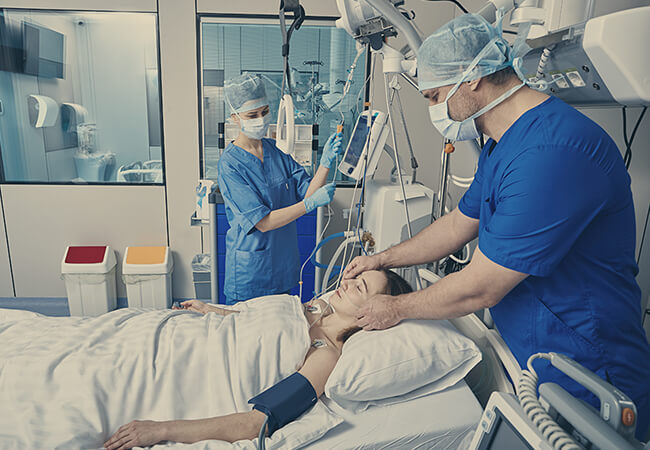 Nurses in ICU taking care of a patient.