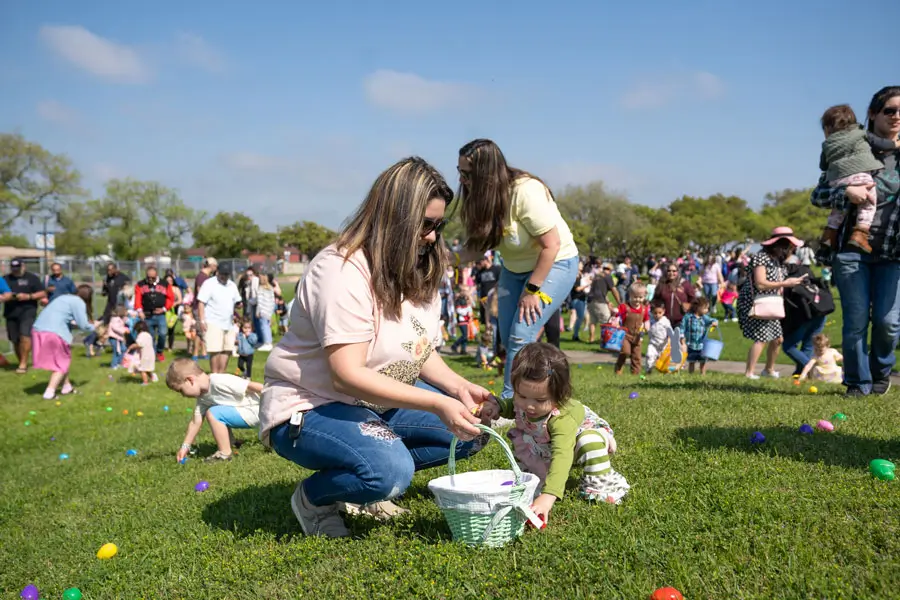 Small kids picking eggs off lawn