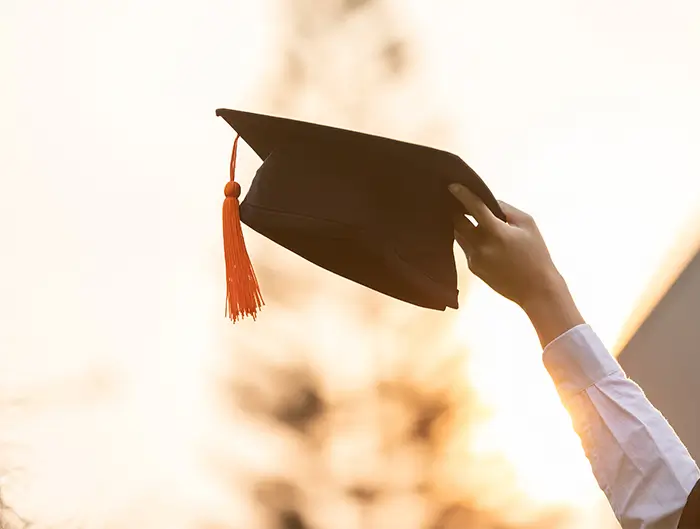 graduation cap being lifted into the air.