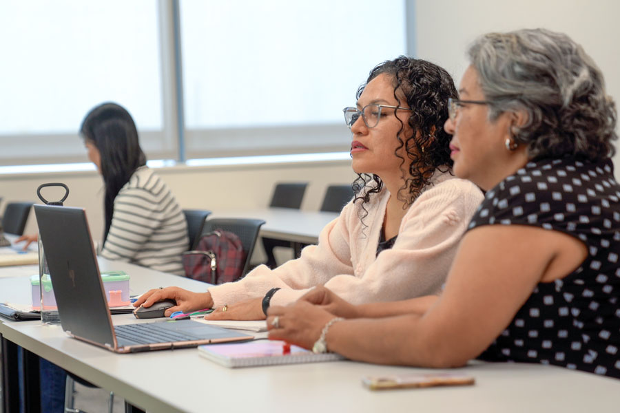 A student receives assistance during an English as a second language class.