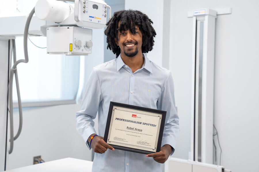 Photo of Robel Araya with his professionalism award.