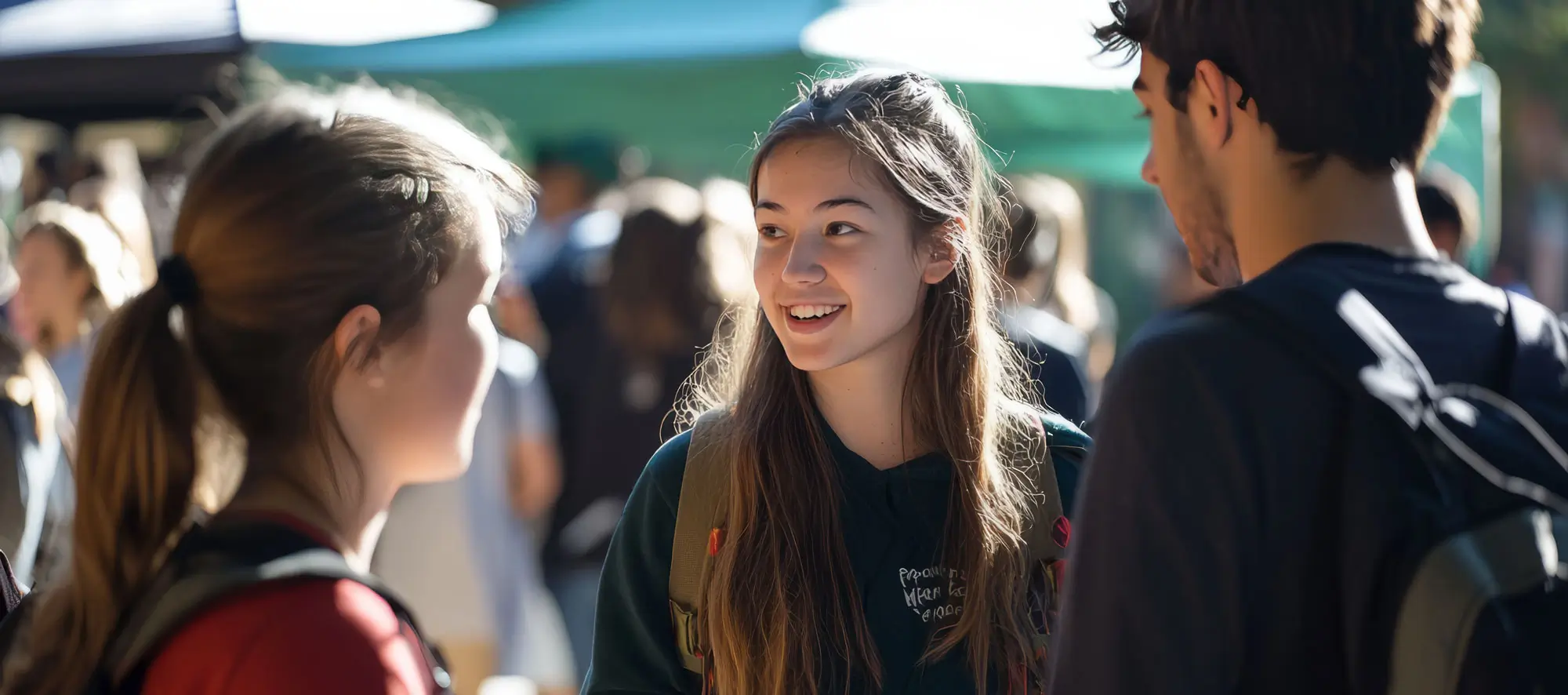 Students are gathered at a club fair on campus.