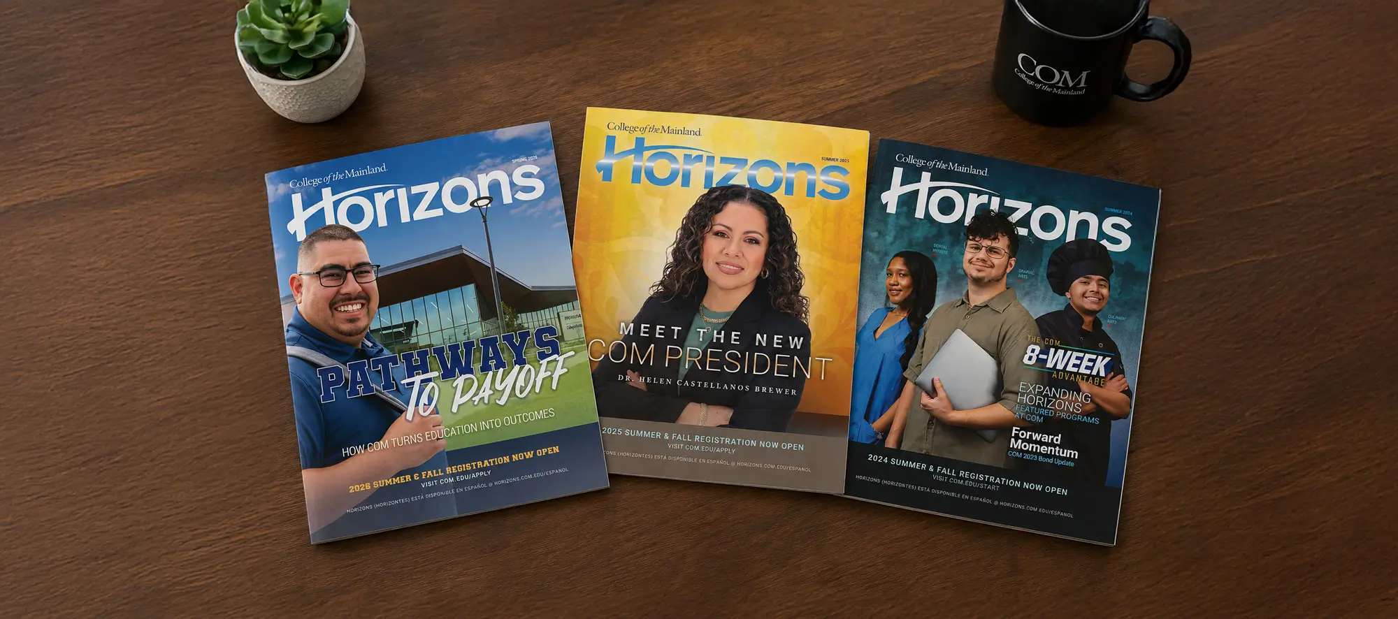 Magazines spread out on a wooden desk.