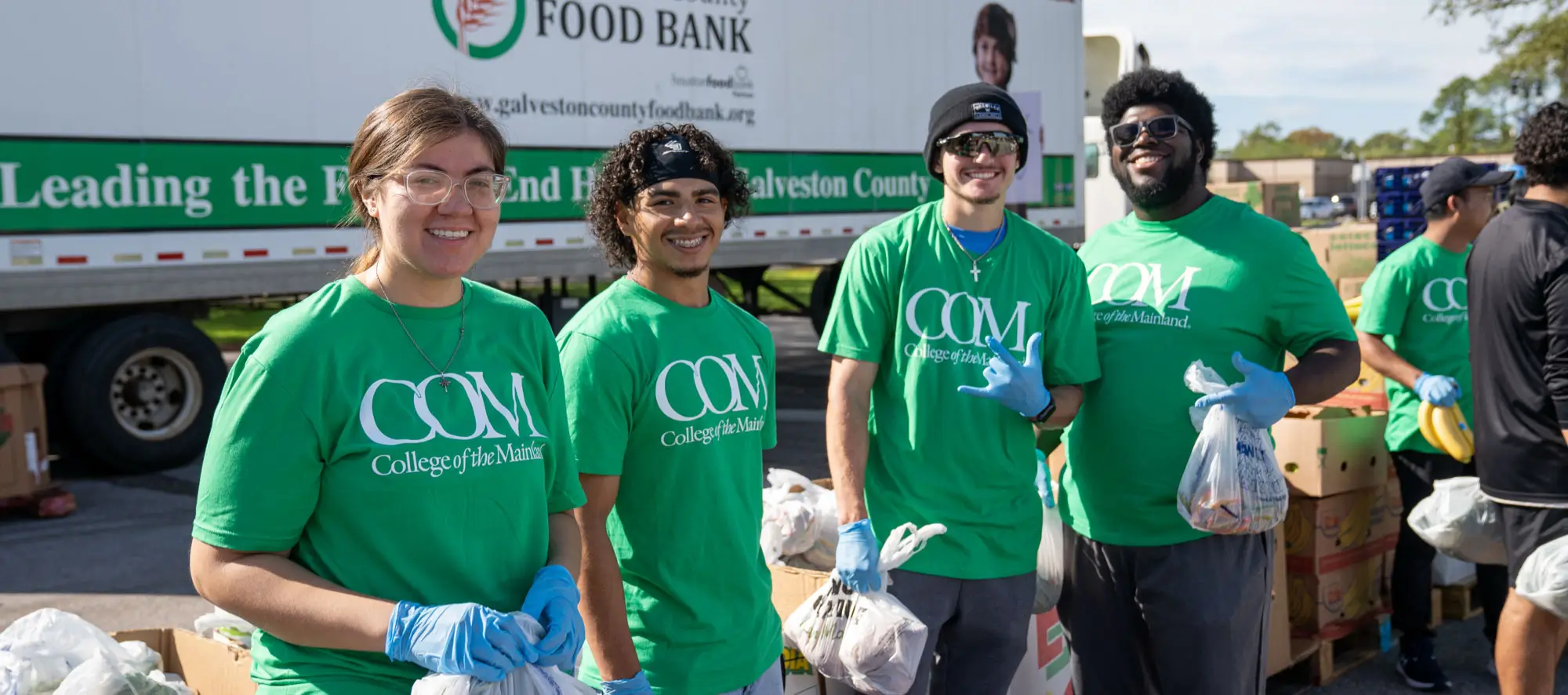 Group of students handing out food at food drive