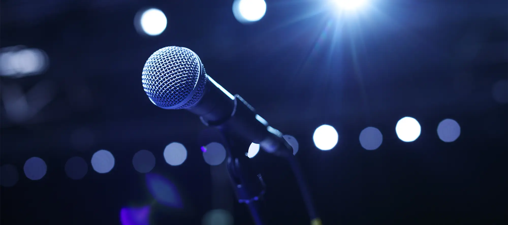 Microphone on blurry blue background.