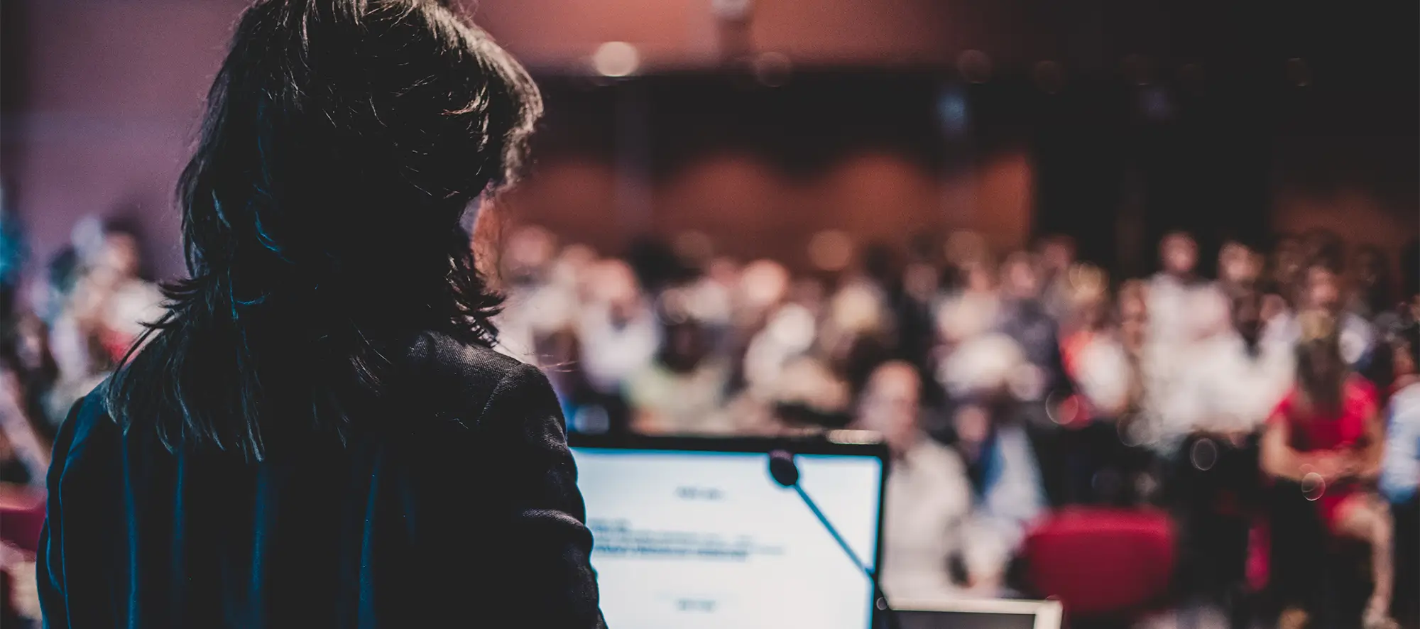 Person speaking to a crowd.