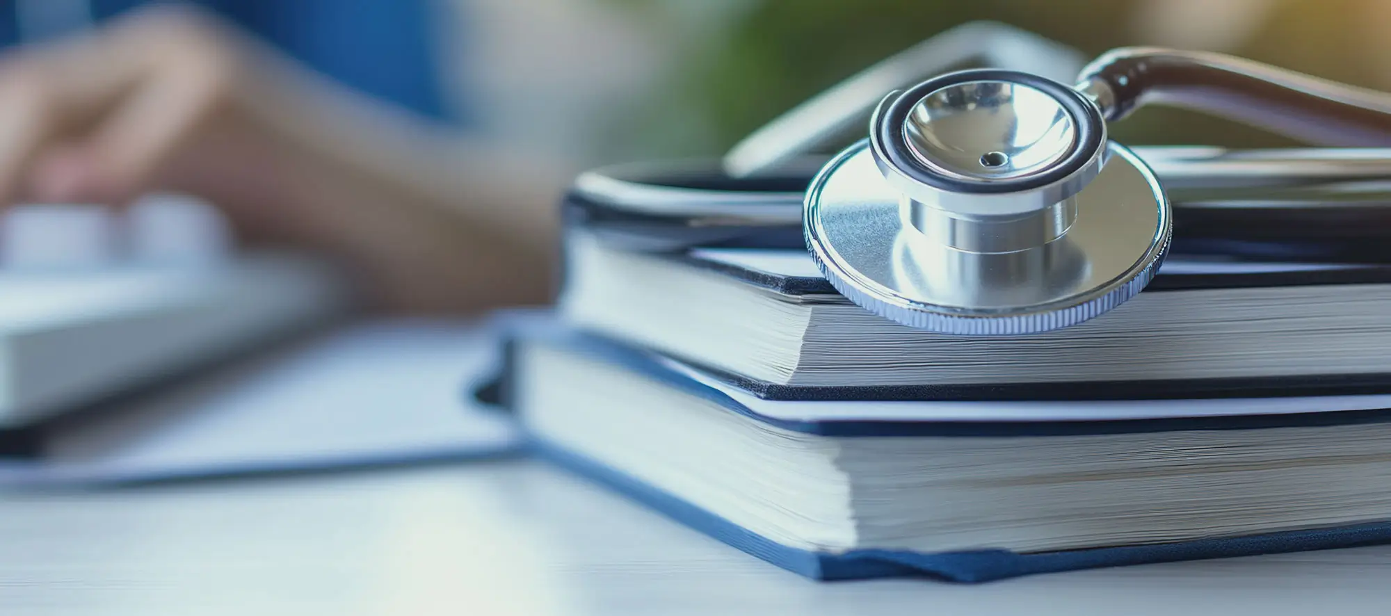 Stack of books with stethoscope on top.