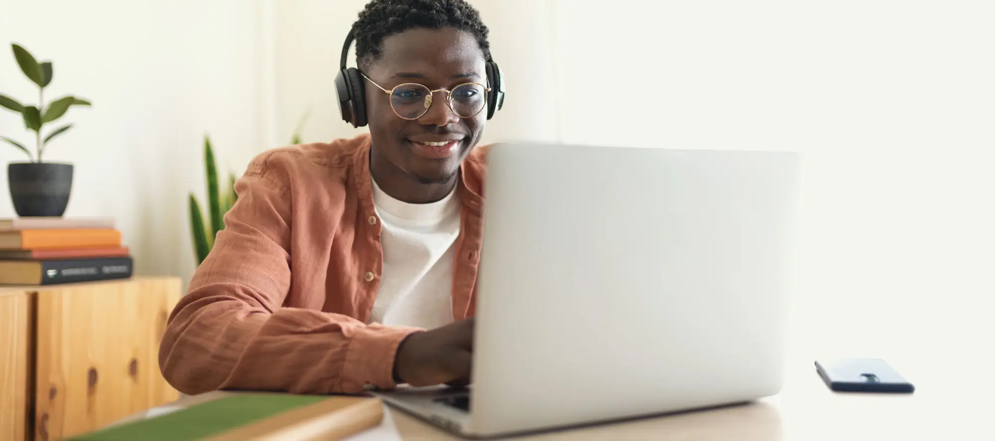 Teen African American college student taking online exam.