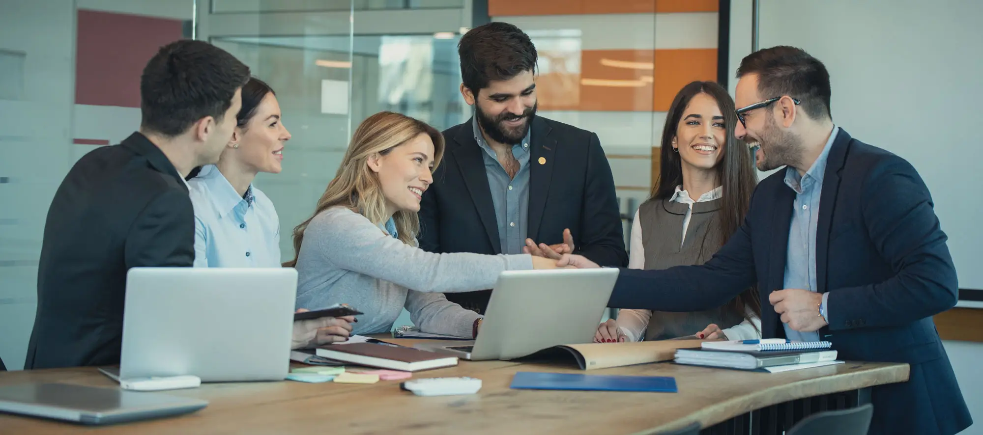 Business colleagues around the table making strong business team.
