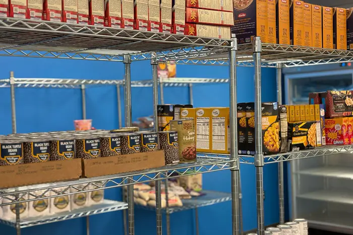 Metal shelves with a variety of non-perishable items.