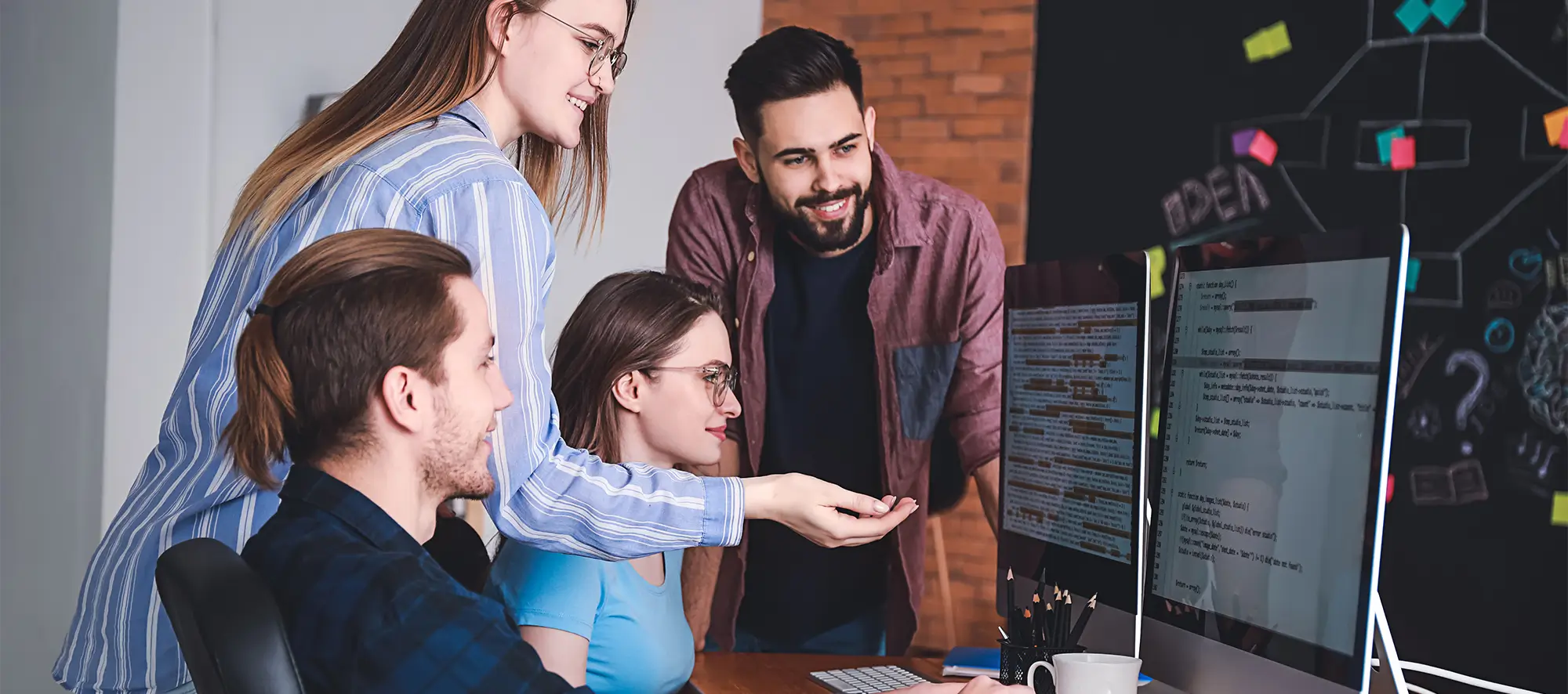 group of people looking at a computer