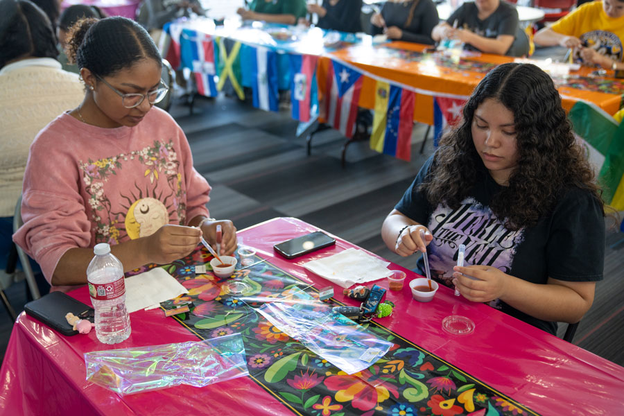 Two students working on activities at the Belleza Latina event