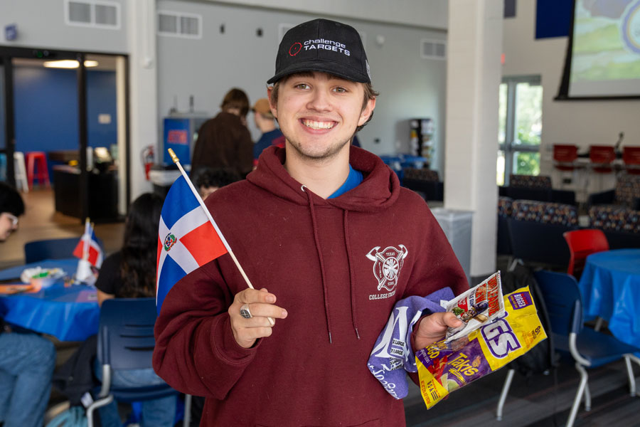 student at event holding a dominican flag