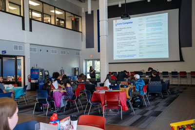 Students at tables at event